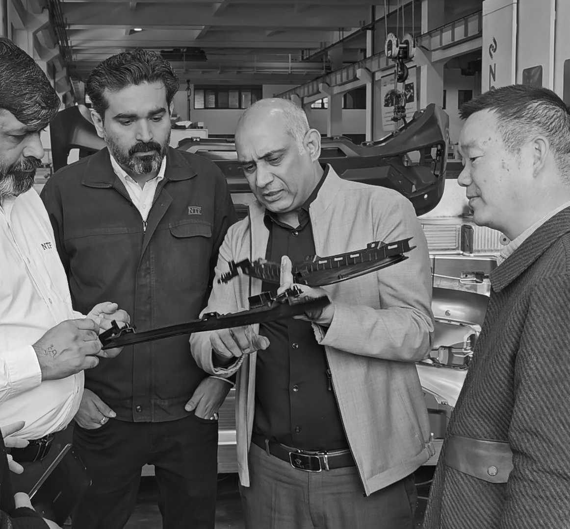 Hongyi JIG team reviewing a moulded part with client engineers